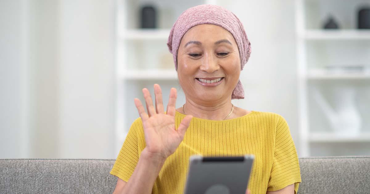 Person waving at tablet Person waving at tablet