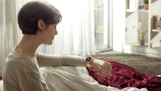 Person looking at their smart watch Person looking at their smart watch