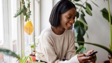 Person using an app on her smart phone Person using an app on her smart phone