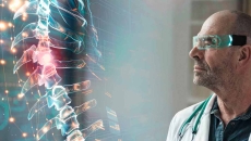 Doctor looking at holographic spinal image Doctor looking at holographic spinal image