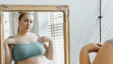 A person looking at their reflection in a mirror A person looking at their reflection in a mirror