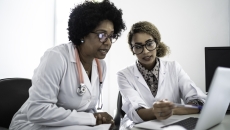 Healthcare professionals reviewing data on a labtop  Healthcare professionals reviewing data on a labtop