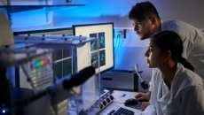 Researchers evaluating a software-driven report  Researchers evaluating a software-driven report