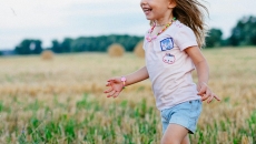 A child running in a field A child running in a field