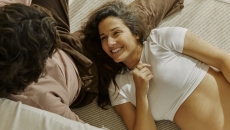 Person lying on another person's lap and wearing a ring