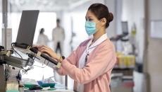 Healthcare provider in a clinic looking at a computer