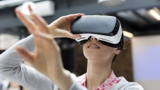 Woman looking into virtual reality glasses Woman looking into virtual reality glasses