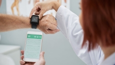 Healthcare professional explaining smart watch and smart phone link Healthcare professional explaining smart watch and smart phone link