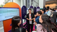 Attendees of Synapxe's first AI conference at a booth Attendees of Synapxe's first AI conference at a booth