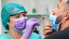 A provider conducting a COVID-19 test. A provider conducting a COVID-19 test.