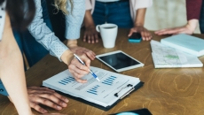 Workers reviewing and analyzing data Workers reviewing and analyzing data