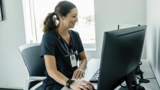 Healthcare professional looking at a PC screen Healthcare professional looking at a PC screen