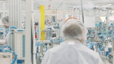 Workers in a Cue Health manufacturing facility Workers in a Cue Health manufacturing facility