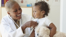 Healthcare professional with infant Healthcare professional with infant