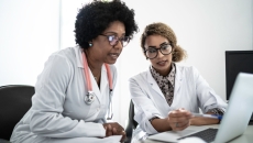 Two healthcare providers on a computer Two healthcare providers on a computer