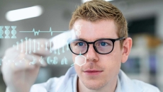 Scientist in a laboratory holding a microscope slide with digitization display in a laboratory Scientist in a laboratory holding a microscope slide with digitization display in a laboratory