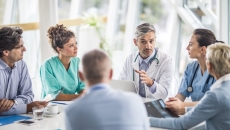 medical providers and business people sit around table medical providers and business people sit around table
