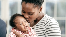 A person holds an infant A person holds an infant