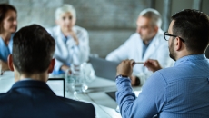 Business persons sitting around a table Business persons sitting around a table