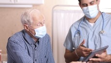 Healthcare provider and senior citizen on a tablet Healthcare provider and senior citizen on a tablet