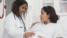 Healthcare provider evaluating a pregnant person Healthcare provider evaluating a pregnant person
