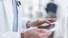 Healthcare provider's hands holding a tablet Healthcare provider's hands holding a tablet