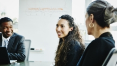 Three business people sitting at a table Three business people sitting at a table