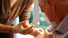 Healthcare practitioners administering injection to patient Healthcare practitioners administering injection to patient