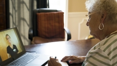 Patient consulting with healthcare practitioner via laptop computer Patient consulting with healthcare practitioner via laptop computer