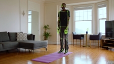 A man standing on a yoga mat while computer vision monitors his movement A man standing on a yoga mat while computer vision monitors his movement