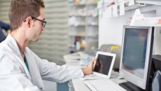 Clinician looking at data on a smart pad tablet and computer screen Clinician looking at data on a smart pad  tablet and computer screen