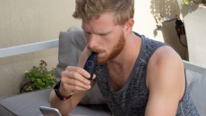 A man using the Lumen device while looking at his phone. A man using the Lumen device while looking at his phone.