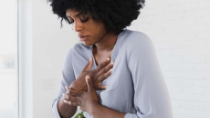 Person holding their chest Person holding their chest