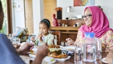 Family sitting at a table eating dinner