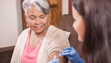 Health care professional administering an injectable medication Health care professional administering an injectable medication