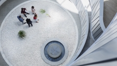 Employees gathering  in an atrium Employees gathering in an atrium