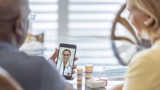 People interacting with a healthcare professional via a smart phone People interacting with a healthcare professional via a smart phone