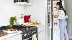 Person looking into a refrigerator Person looking into a refrigerator