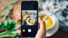 Person taking a photo of their meal with a smartphone Person taking a photo of their meal with a smartphone