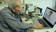 Person consulting with physician via laptop Person consulting with physician via laptop