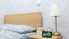 An Alexa device on a bedside table with a Vayyar sensor above the bed. An Alexa device on a bedside table with a Vayyar sensor above the bed.