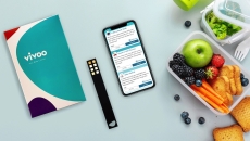 A photo of the Vivoo test kit next to a smartphone and a lunchbox. A photo of the Vivoo test kit next to a smartphone and a lunchbox.