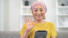 Person waving at tablet Person waving at tablet
