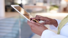 A close up photo of a woman using a tablet. A close up photo of a woman using a tablet.