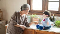 A senior individual interacting with an AI companion doll A senior individual interacting with an AI companion doll