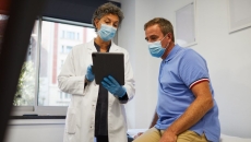 A medical professional showing a patient information on a tablet A medical professional showing a patient information on a tablet