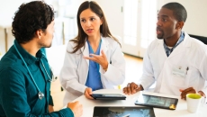 Doctors discussing imaging results. Doctors discussing imaging results.