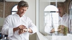 A man in an office wearing a smartwatch A man in an office wearing a smartwatch