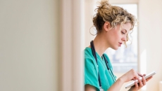 A provider typing onto a tablet A provider typing onto a tablet