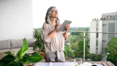 An older woman using a tablet. An older woman using a tablet.
